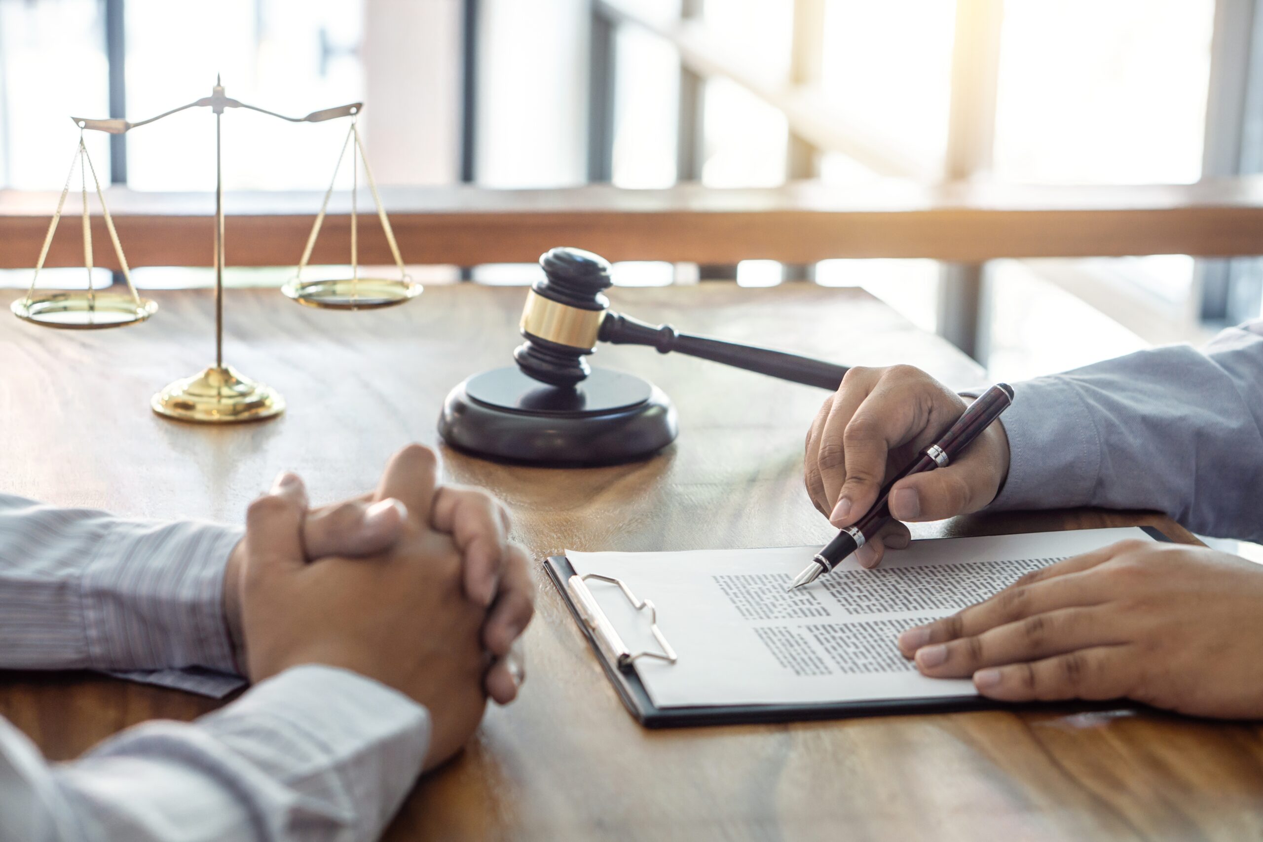 Law, lawyer attorney and justice concept, Consultation between a male lawyer and client, giving advice and prosecutions about the regarding real estate, report of the important case in the workplace.