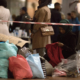 COPENHAGEN, DENMARK - SEPTEMBER 15, 2015: Female aid worker is distributing children's clothes donated by locals to Syrian refugees.