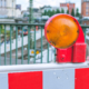 Orange construction warning street barrier light on barricade. Road construction on the streets of European cities. Germany. Hamburg.