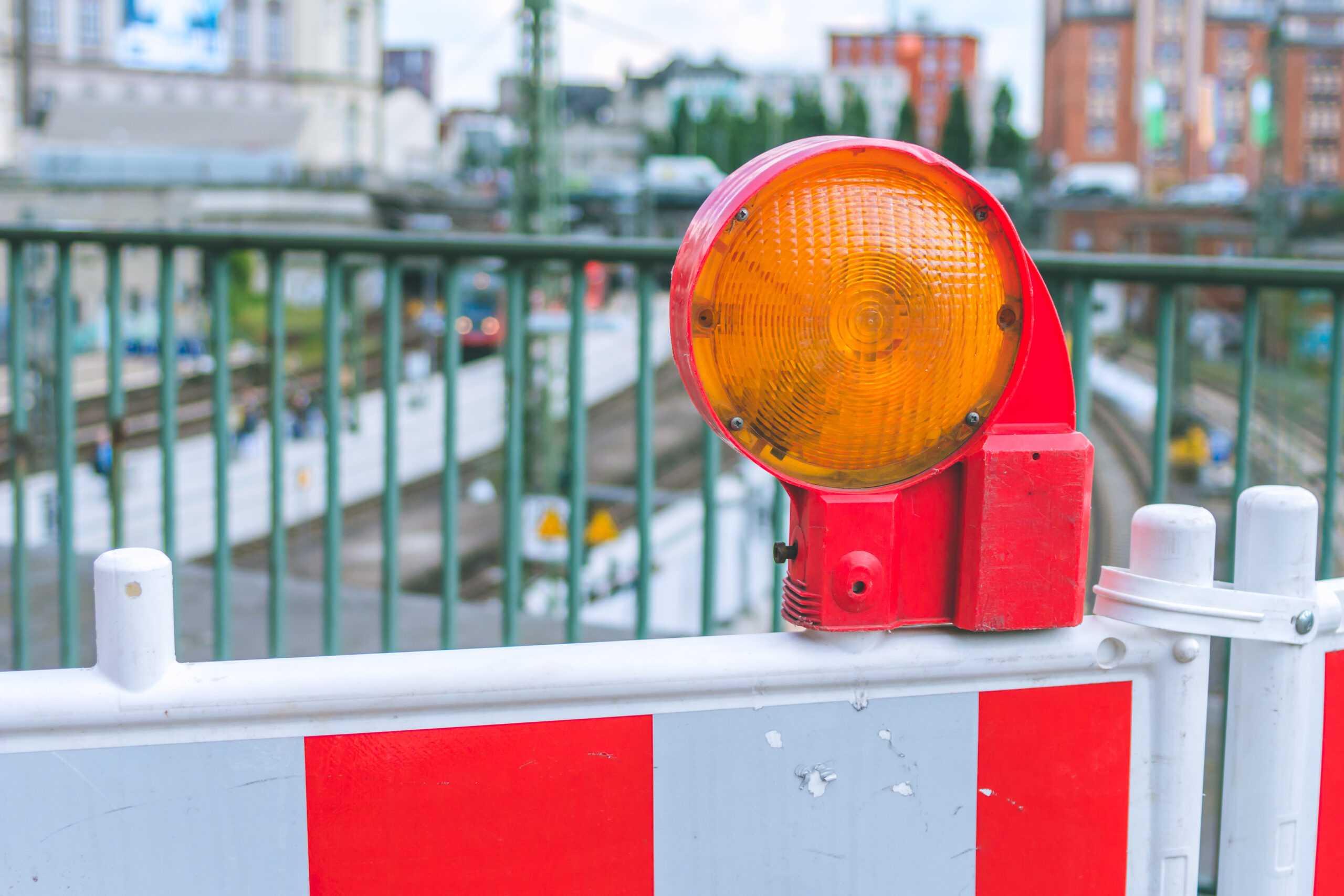 Orange construction warning street barrier light on barricade. Road construction on the streets of European cities. Germany. Hamburg.