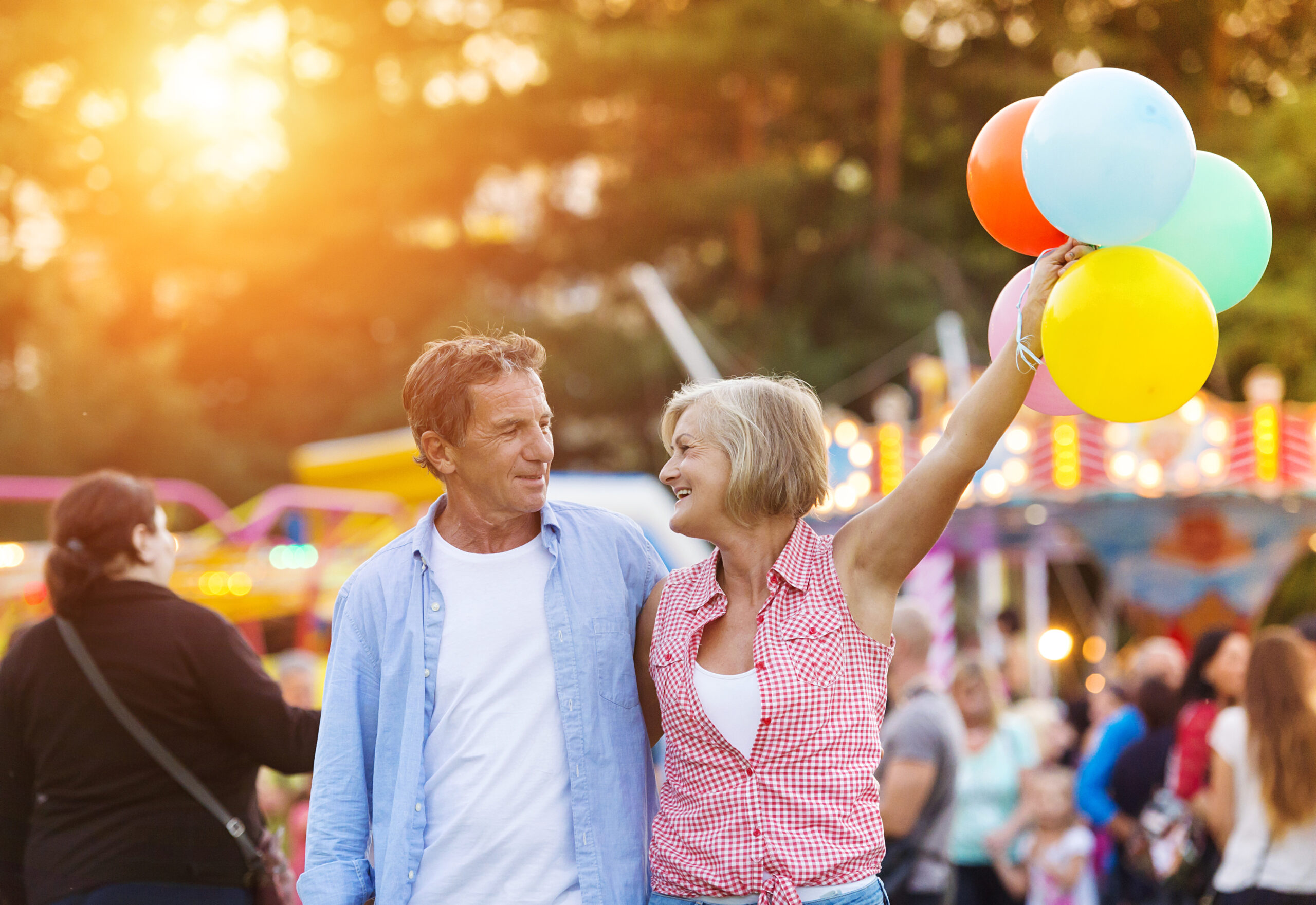 Senior couple having a good time at the fun fair