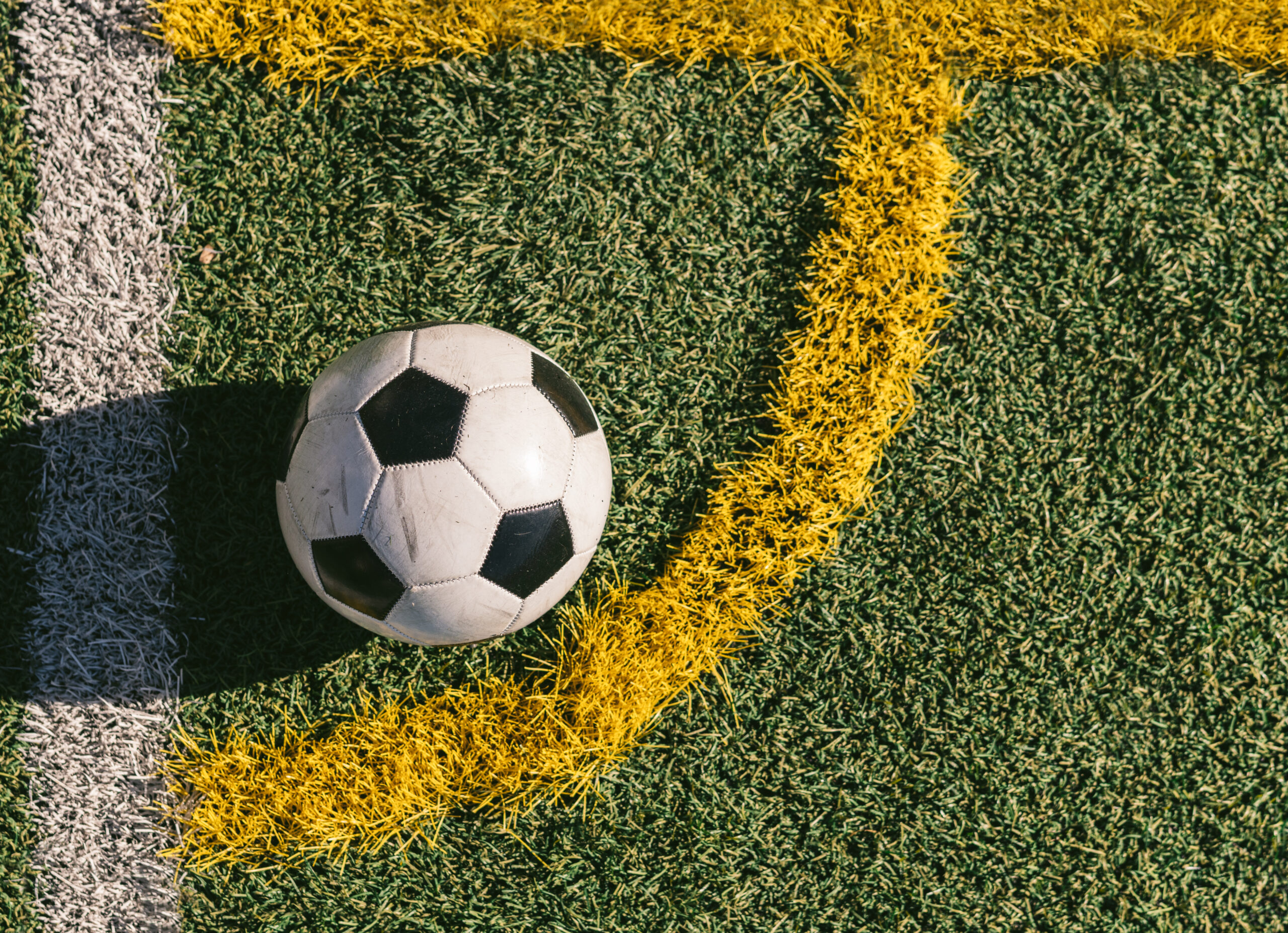 football placed in the corner of a football field. Sport