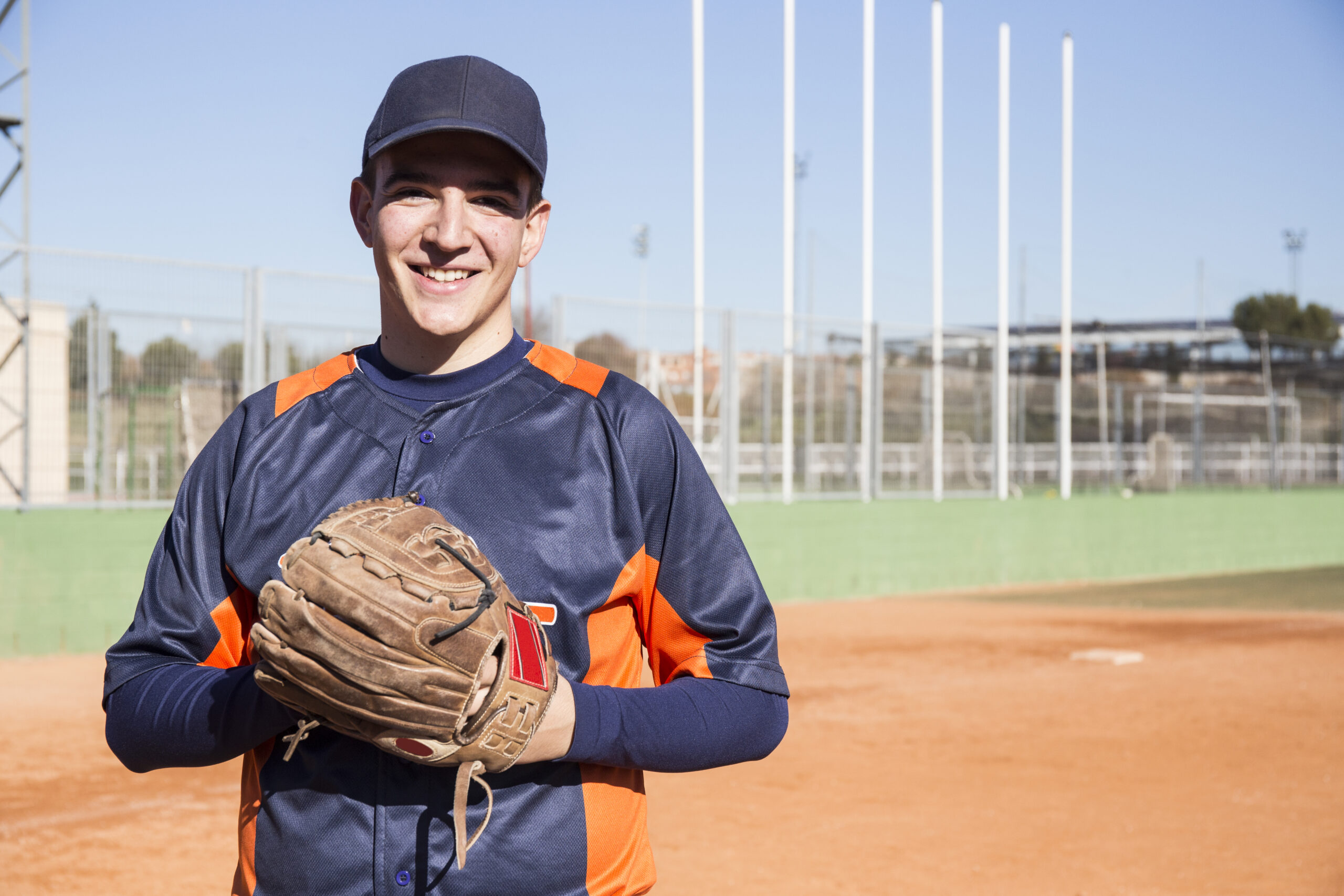 Portrait of smiling baseball player with a baseball glove