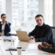 High angle portrait of successful businesswoman using wheelchair while leading business meeting in office with diverse group of people