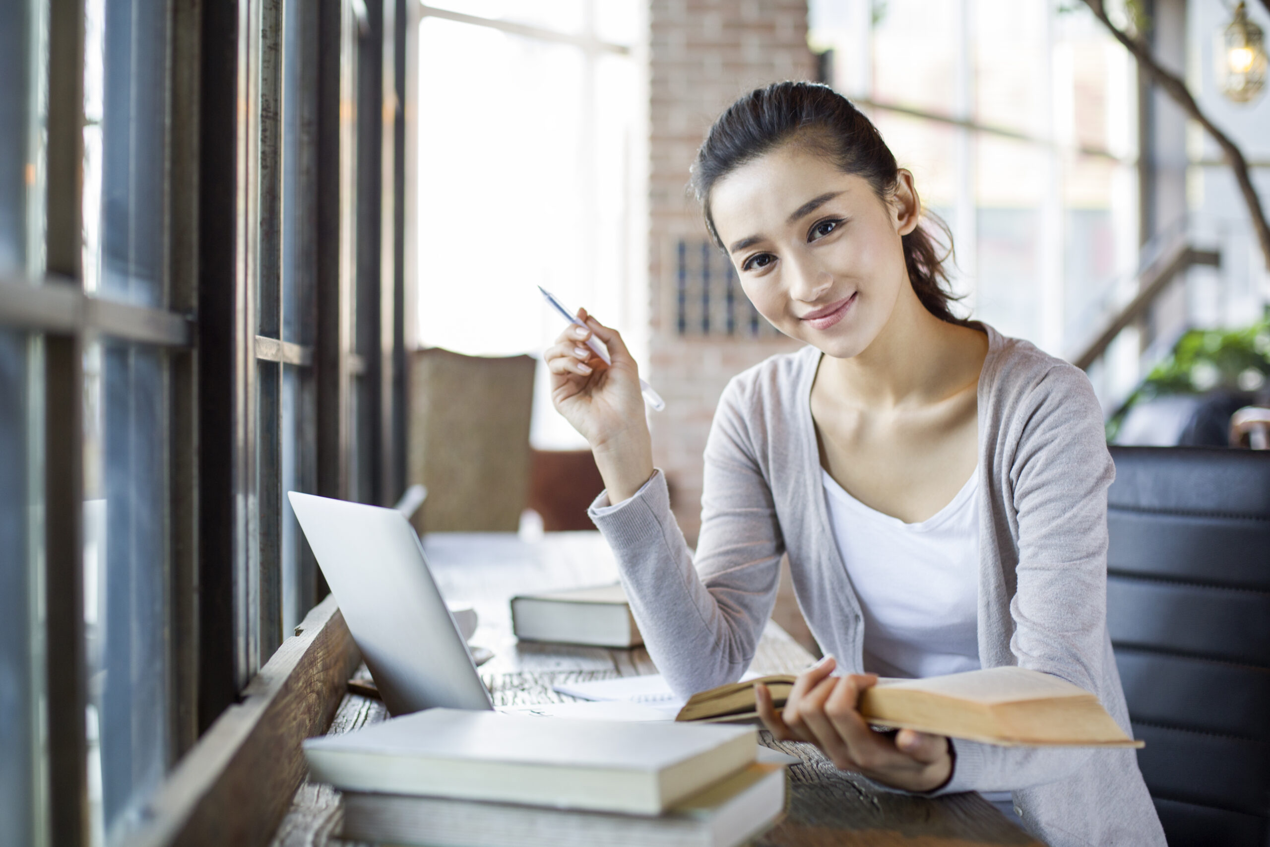 Young Chinese woman studying in cafe