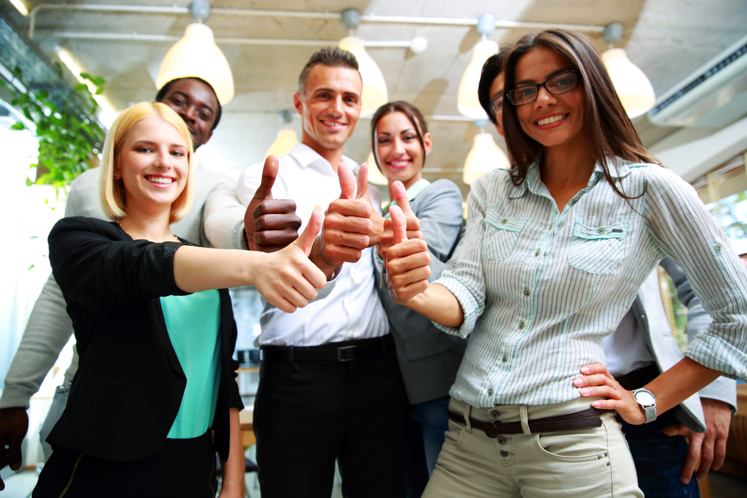 Happy business group giving thumbs up