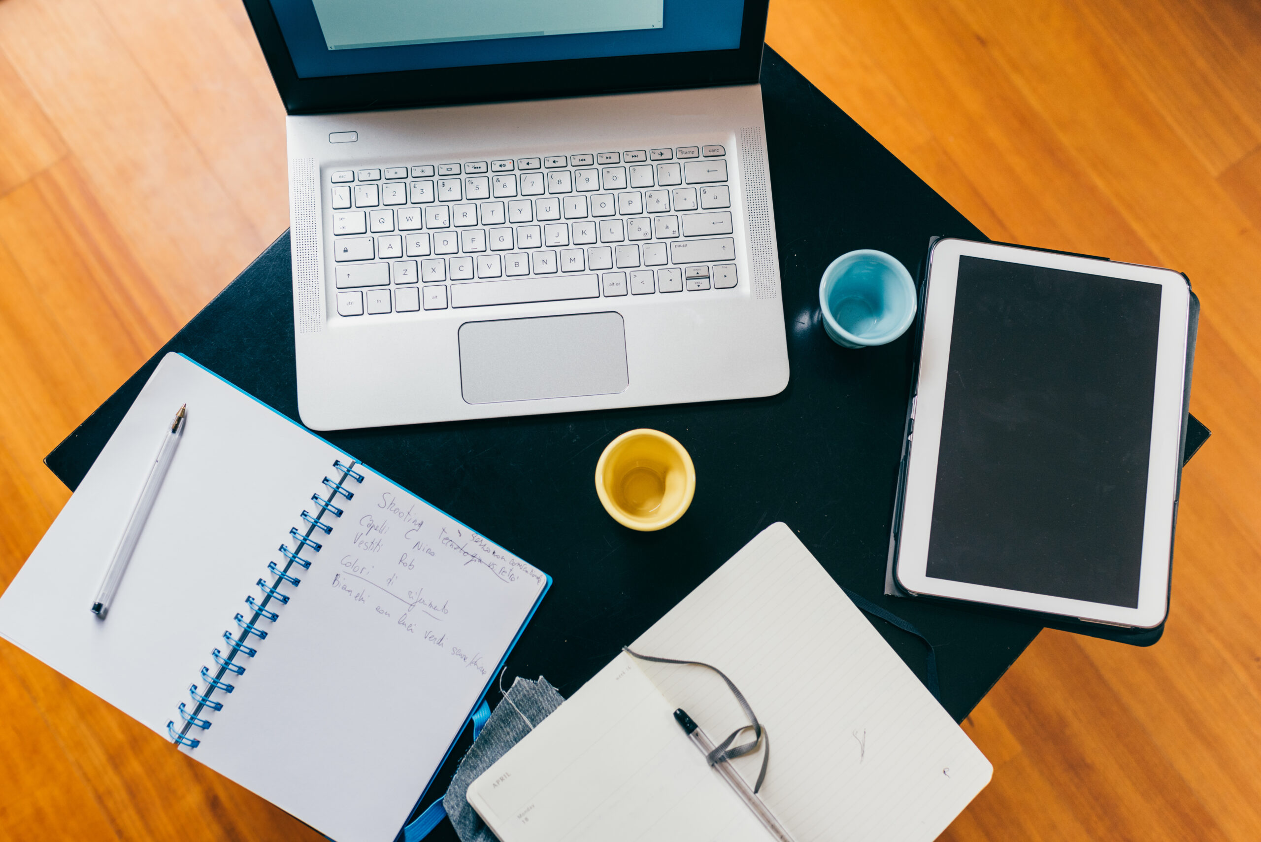 Top view of office desk table with organizer, notebook, tablet, pencil and cups of coffee - business, work, meeting concept